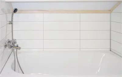 a bathroom with a tub with a shower and a sink at Three-Bedroom Holiday Home In Sjusjoen in Sjusjøen