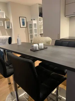 a dining room table with two candles on it at Førde in Førde