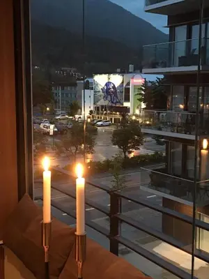 two candles on a window with a view of a parking lot at Førde in Førde