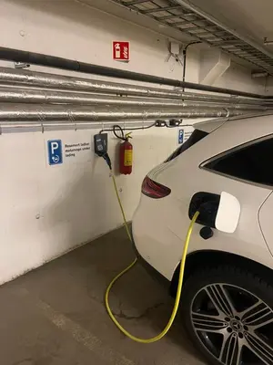 a white car is being charged in a garage at Førde in Førde