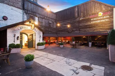 a building with a patio with tables and chairs at Quality Hotel Prinsen in Trondheim
