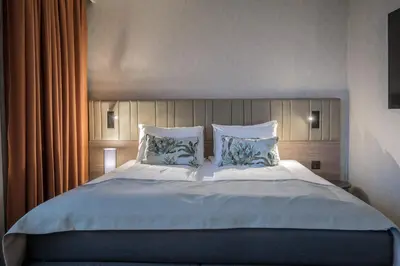 a bedroom with a large bed with two pillows at Quality Hotel Prinsen in Trondheim
