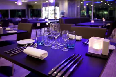 a table with wine glasses and napkins on it at Quality Hotel Waterfront in Ålesund