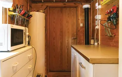 a kitchen with a microwave on top of a refrigerator at Three-Bedroom Holiday Home In Sjusjoen in Sjusjøen