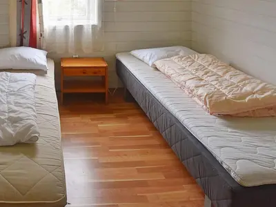 a room with two beds and a table in it at 7 person holiday home in Selje-By Traum in Selje