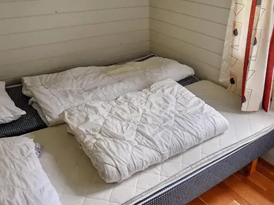 two unmade beds sitting on top of avisor at 7 person holiday home in Selje-By Traum in Selje