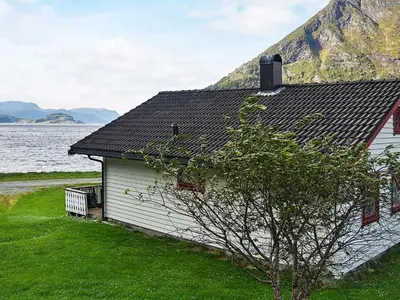 a building next to a body of water at 7 person holiday home in Selje-By Traum in Selje