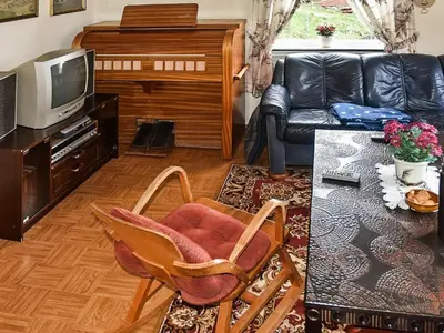 a living room with a couch and a television at 8 person holiday home in FINNÅS in Vordnes