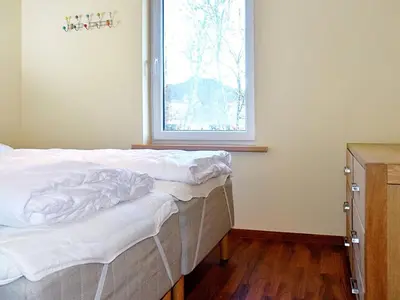an unmade bed in a room with a window at 6 person holiday home in EIDSVÅG in Eidsvåg
