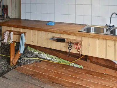 a kitchen counter with a sink and a pair of scissors at 4 person holiday home in Måndalen in Sæbø
