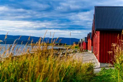 a red fence next to a body of water at Ørland Kysthotell in Brekstad