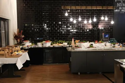 a restaurant with a buffet line with food on counters at Ørland Kysthotell in Brekstad