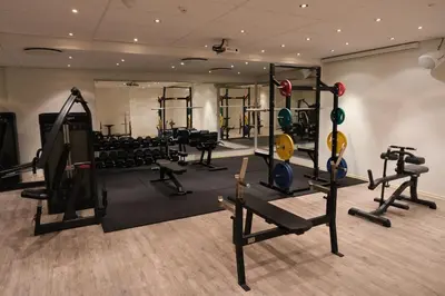 a gym with treadmills and machines in a room at Ørland Kysthotell in Brekstad