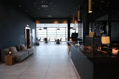 a living room with a couch and a table at Ørland Kysthotell in Brekstad