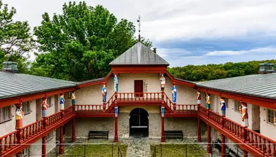an old building with a porch and a courtyard at Ørland Kysthotell in Brekstad