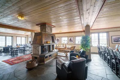 a large living room with a fireplace in the middle at Hustadvika Havhotell - by Classic Norway Hotels in Farstad