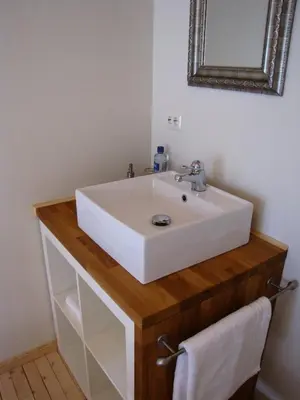 a bathroom with a white sink and a mirror at Nordbø Pensjonat in Hjartdal