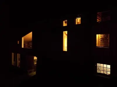 a building in the dark with lights in the windows at Ein heilt spesiell låve i Røldal in Røldal