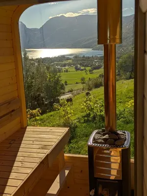 a porch with a view of a lake and mountains at Ein heilt spesiell låve i Røldal in Røldal
