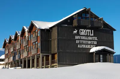 a building with a sign on it in the snow at Grotli Høyfjellshotell in Grotli