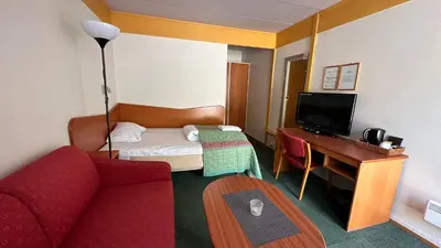 a hotel room with a bed and a desk at Sødorp Gjestgivergård Motell in Vinstra