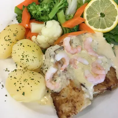 a plate of food with shrimp and vegetables on it at Sødorp Gjestgivergård Motell in Vinstra
