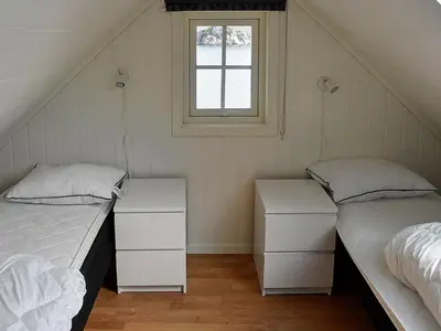 two beds in a room with a window at 8 person holiday home in Urangsvåg-By Traum in Ervik