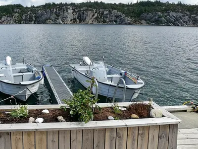 two boats are docked at a dock on a lake at 8 person holiday home in Urangsvåg-By Traum in Ervik