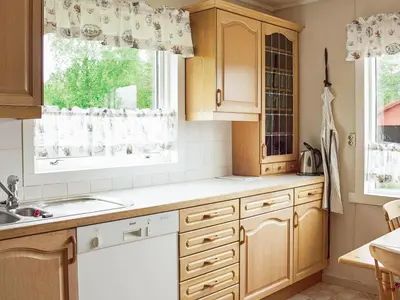 a kitchen with wooden cabinets and a window at 8 person holiday home in VÅGLAND-By Traum in Vågland