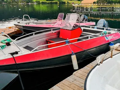 two boats are docked at a dock in the water at 8 person holiday home in VÅGLAND-By Traum in Vågland