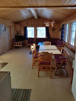a dining room with a table and chairs in a room at Solstua Three-bedroom Cottage in Geilo