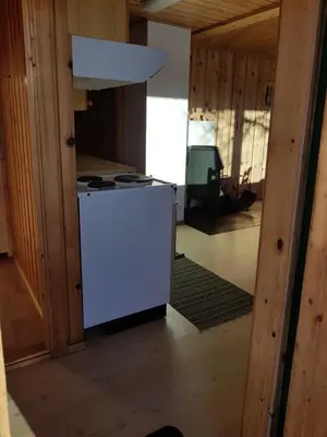 a kitchen with a white refrigerator in a room at Solstua Three-bedroom Cottage in Geilo