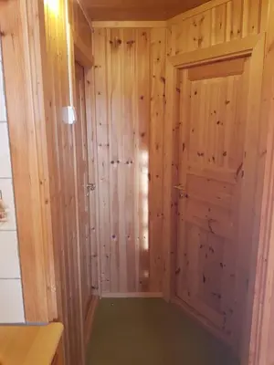 a room with a closet with a door at Solstua Three-bedroom Cottage in Geilo