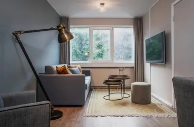 a living room with a couch and a table at Førde Hotel - Unike Hoteller in Førde