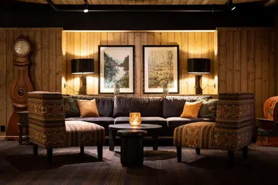a living room with a couch and two chairs and a table at Bardøla Fjelltun in Geilo