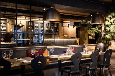 a restaurant with tables and chairs with glasses on them at Bardøla Fjelltun in Geilo
