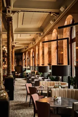a restaurant with tables and chairs in a building at Opus 16, a Member of Small Luxury Hotels in Bergen