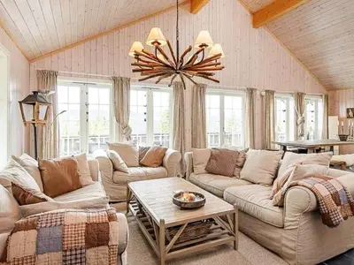 a living room with couches and a chandelier at 11 person holiday home in Fåvang-By Traum in Favang