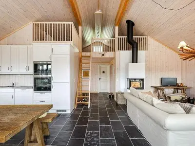 a living room with a white couch and a wooden ceiling at 11 person holiday home in Fåvang-By Traum in Favang