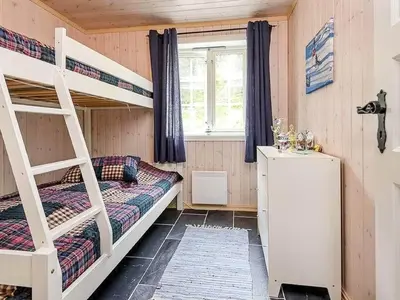 a bedroom with two bunk beds and a window at 11 person holiday home in Fåvang-By Traum in Favang