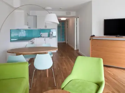 a kitchen and dining room with a table and chairs at Thon Hotel Sandven in Norheimsund