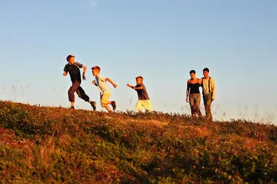 a group of young men running up a hill at Hovden Fjellstoge in Hovden