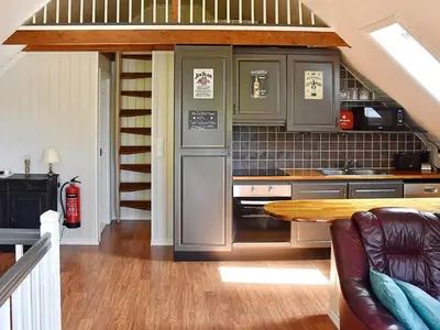 a kitchen with stainless steel appliances and a table at 4 person holiday home in Urangsvåg-By Traum in Ervik