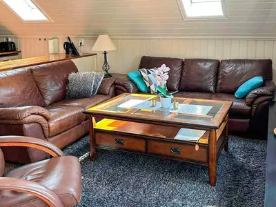 a living room with leather couches and a coffee table at 4 person holiday home in Urangsvåg-By Traum in Ervik