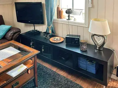 a living room with a black table with a lamp and a tv at 4 person holiday home in Urangsvåg-By Traum in Ervik