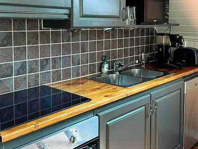 a kitchen counter with a sink and a microwave at 4 person holiday home in Urangsvåg-By Traum in Ervik