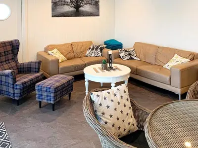 a living room with a couch and chairs and a table at 8 person holiday home in Urangsvåg-By Traum in Ervik