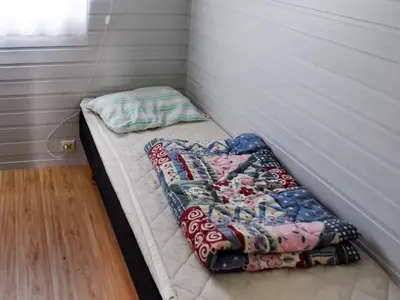 a small bed in a corner of a room at 5 person holiday home in Selje-By Traum in Selje