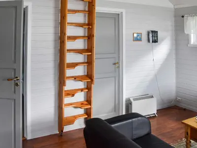a spiral staircase in a living room with a couch at 5 person holiday home in Selje-By Traum in Selje