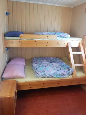two bunk beds in a small room with a bed at Knutebu Two-Bedroom Cottage in Geilo